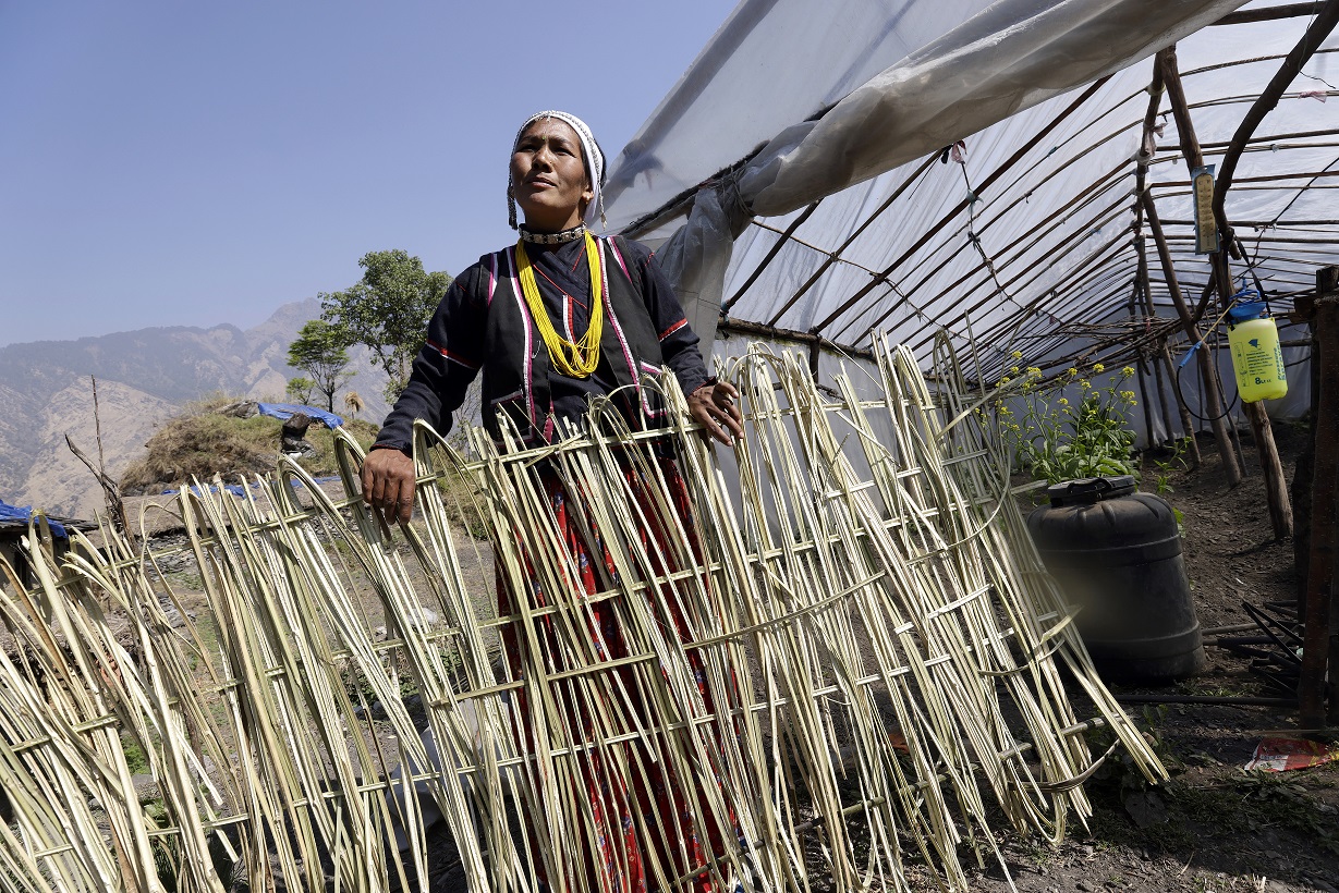 Sangita Bohara in front of her greenhouse.