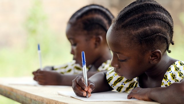 African children writing at school.