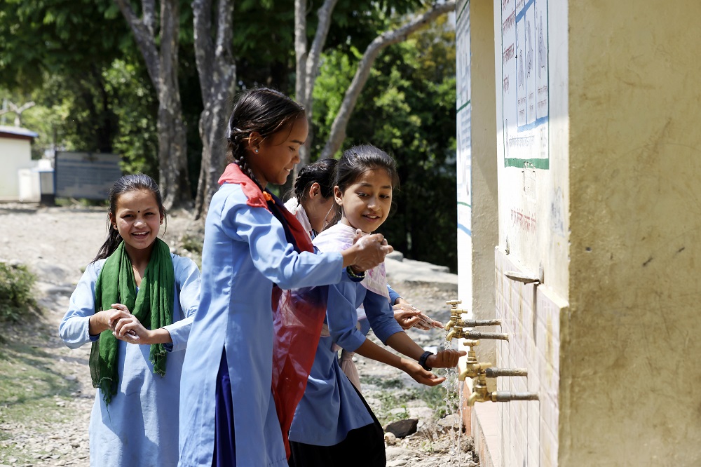 School girls washing their hands.