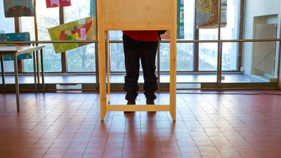 person in voting booth 