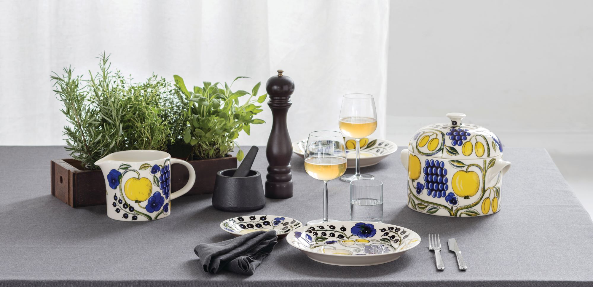 Colorful patterned Arabia dishes, herbs and spices in a kitchen setting.