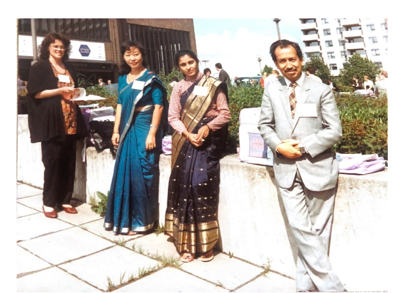 Four people standing in front of a fence in Helsinki, one Finnish female from the project along with two Nepalese women and one Nepalese male. 