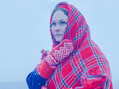 Sámi woman with wintery background