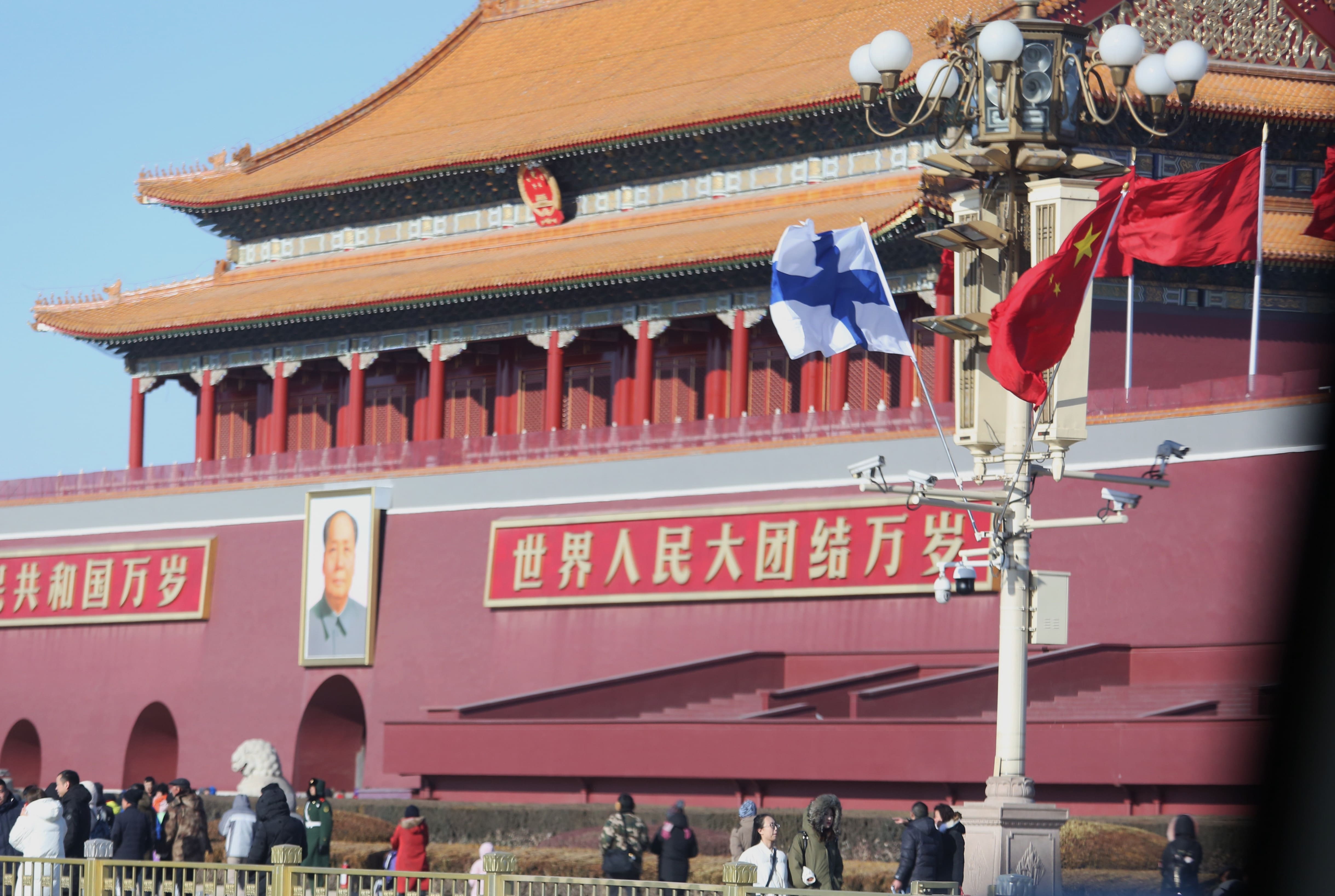 Finnish and Chinese flags in front of the Forbidden City