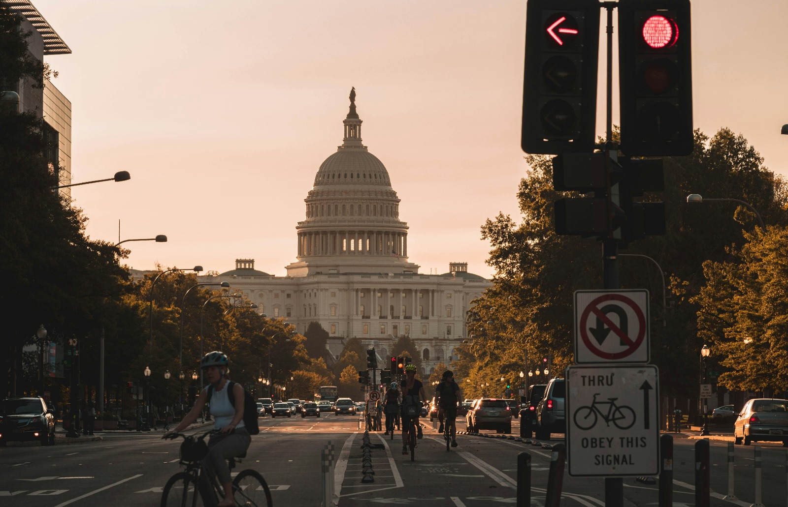 Bikers riding in front of the U.S. Capitol close to sunset.