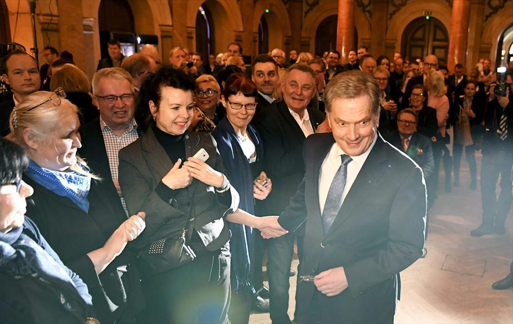 Sauli Niinistö smiles for the cameras at an election-night reception in Helsinki after results showed that he had won a second six-year term as president.