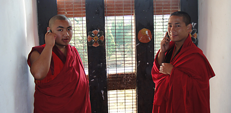 Tibetan Buddhist monks speaking on mobile phones.